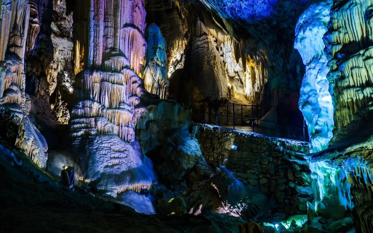 Illuminated stalactites and columns inside Postojna Cave in Slovenia