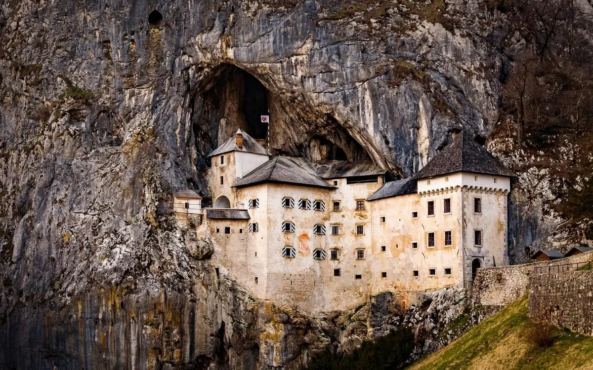Predjama Castle built into a cliff face above a cave mouth